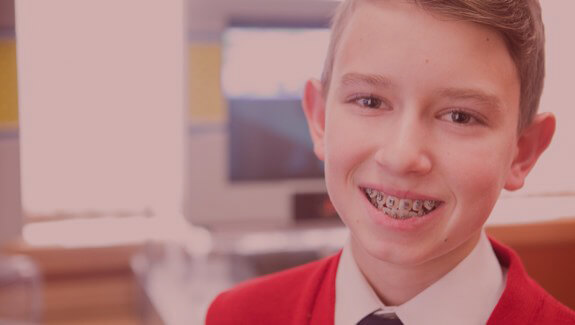 Boy smiling with braces | SmilePerfect Orthodontists in Cedar Hills UT